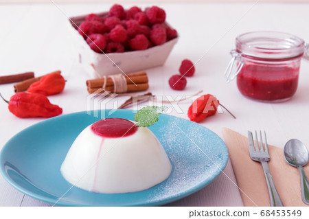 Panna Cotta, traditional sweet Italian dessert with raspberry puree and touch of Bhut jolokia chilli 68453549