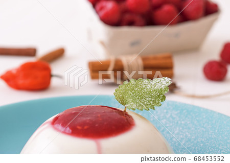 Panna Cotta, traditional sweet Italian dessert with raspberry puree and touch of Bhut jolokia chilli 68453552