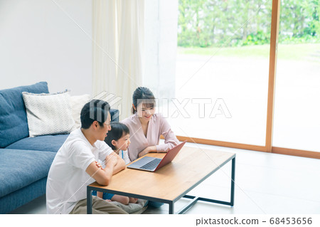 Family looking at a computer Family conference Family looking at a computer Family conference 68453656