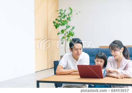 Family looking at a computer Family conference Family looking at a computer Family conference 68453657
