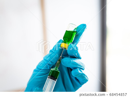 Doctors or scientists prepare a vaccine to prevent a new strain of influenza to inject the patient to create immunity in the body, Vaccinate concept. 68454857