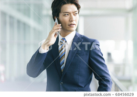 Businessman talking on a smartphone 68456029