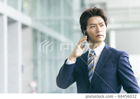 Businessman talking on a smartphone Businessman talking on a smartphone 68456032