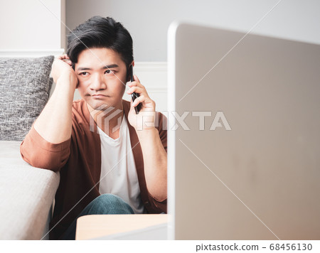 Asian young man rubbing his tired eyes his Asian young man rubbing his tired eyes his 68456130