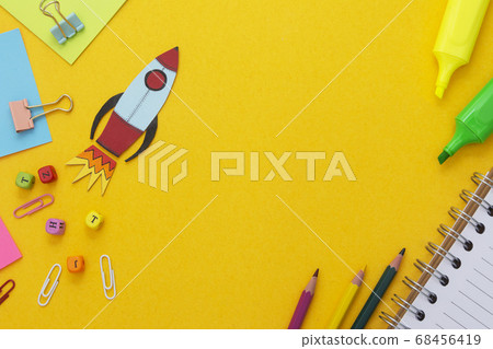 Education development concept. Back to school. Yellow background withschool supplies, notebook, rocket and sticky notes. Mock up. Top view. Education development concept. Back to school. Yellow background withschool supplies, notebook, rocket and sticky notes. Mock up. Top view. 68456419