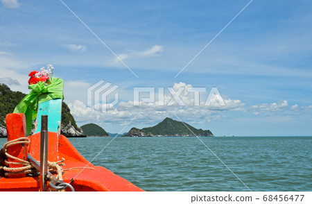 Wooden boat sailing to limestone mountains Wooden boat sailing to limestone mountains 68456477