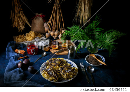 Noodles with poppy seeds, Czech traditional sweet pasta dessert with plum compote, dark background 68456531