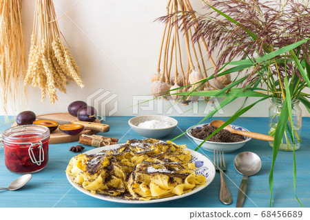 Noodles with poppy seeds, Czech traditional sweet pasta dessert with plum compote, white background 68456689