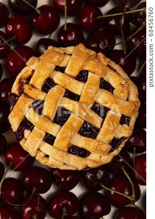 Cherry mini pie with ripe cherries on background of ripe cherries Cherry mini pie with ripe cherries on background of ripe cherries 68456760