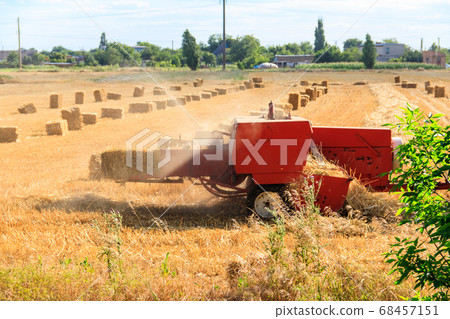 Rectangular baler discharges a straw bale 68457151