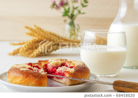 White table with yeasty sweet pastry with fresh currants and raspberries and streusel topping. White table with yeasty sweet pastry with fresh currants and raspberries and streusel topping. 68458020