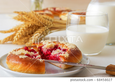 White table with yeasty sweet pastry with fresh currants and raspberries and streusel topping. White table with yeasty sweet pastry with fresh currants and raspberries and streusel topping. 68458027