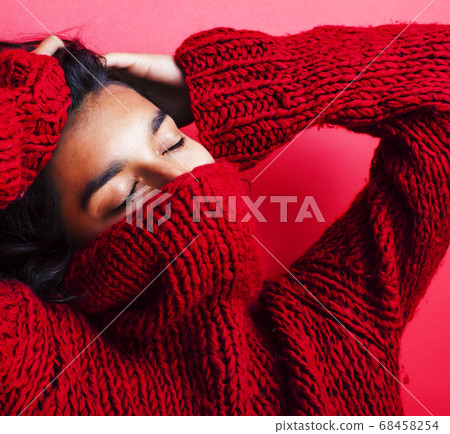 young pretty indian girl in red sweater posing emotional, fashion hipster teenage, lifestyle people concept young pretty indian girl in red sweater posing emotional, fashion hipster teenage, lifestyle people concept 68458254