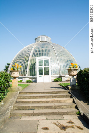 A dome shaped greenhouse under a clear sky at Kew Gardens in the suburbs of London A dome shaped greenhouse under a clear sky at Kew Gardens in the suburbs of London 68458303