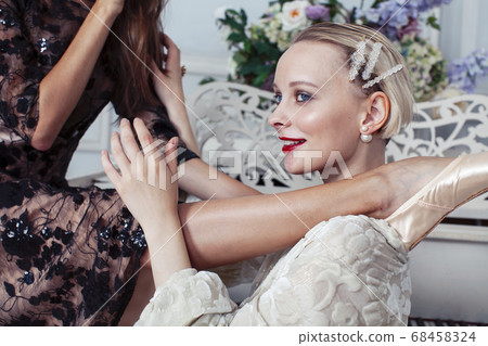 young pretty brunette ballet dancer at piano with blond woman in luxury royal interior, lifestyle rich people concept young pretty brunette ballet dancer at piano with blond woman in luxury royal interior, lifestyle rich people concept 68458324