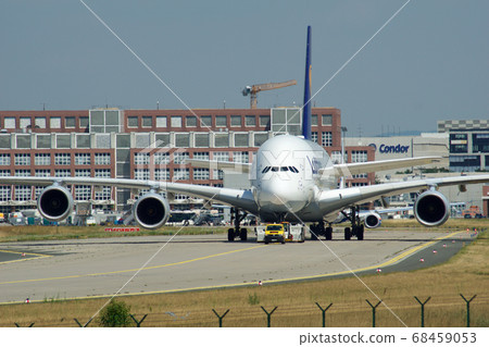 FRANKFURT, GERMANY - JUN 09th, 2017: Airbus A380 of Lufthansa with registration D-AIMH moves on taxiway by tow truck before departure from FRA airport 68459053