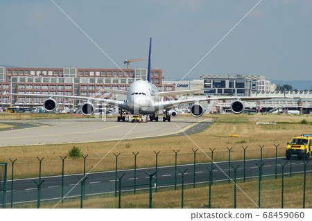 FRANKFURT, GERMANY - JUN 09th, 2017: Airbus A380 of Lufthansa with registration D-AIMH moves on taxiway by tow truck before departure from FRA airport FRANKFURT, GERMANY - JUN 09th, 2017: Airbus A380 of Lufthansa with registration D-AIMH moves on taxiway by tow truck before departure from FRA airport 68459060