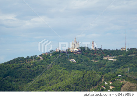 BARCELONA, SPAIN - AUG 30th, 2017: Panoramic view of the city Tibidabo Mountain in far distance from the bunkers de carmel on a cloudy day 68459099