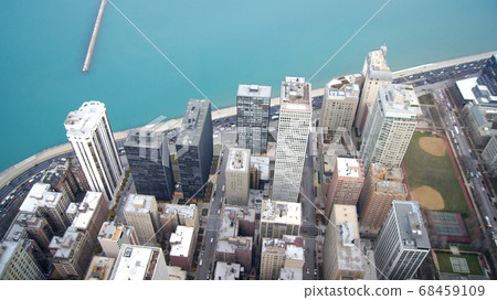 CHICAGO, ILLINOIS, UNITED STATES - DEC 11th, 2015: View from John Hancock tower, Chicago and Lake Michigan panoramic view. City skyline from 360 Chicago observation deck CHICAGO, ILLINOIS, UNITED STATES - DEC 11th, 2015: View from John Hancock tower, Chicago and Lake Michigan panoramic view. City skyline from 360 Chicago observation deck 68459109