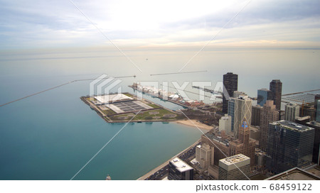 CHICAGO, ILLINOIS, UNITED STATES - DEC 11th, 2015: View from John Hancock tower, Chicago and Lake Michigan panoramic view. City skyline from 360 Chicago observation deck CHICAGO, ILLINOIS, UNITED STATES - DEC 11th, 2015: View from John Hancock tower, Chicago and Lake Michigan panoramic view. City skyline from 360 Chicago observation deck 68459122