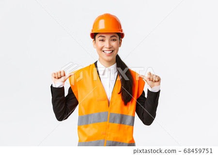 Successful proud smiling asian female construction manager, engineer in safety helmet pointing at herself, show-off. Architect recommend personal assistance, bragging accomplishments Successful proud smiling asian female construction manager, engineer in safety helmet pointing at herself, show-off. Architect recommend personal assistance, bragging accomplishments 68459751