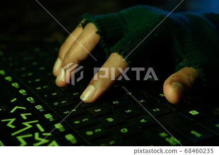 hacker hand stealing data from laptop top down hacker hand stealing data from laptop top down 68460235
