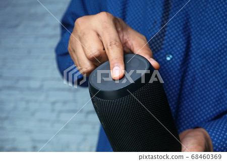 man's hand using smart speaker close up  68460369