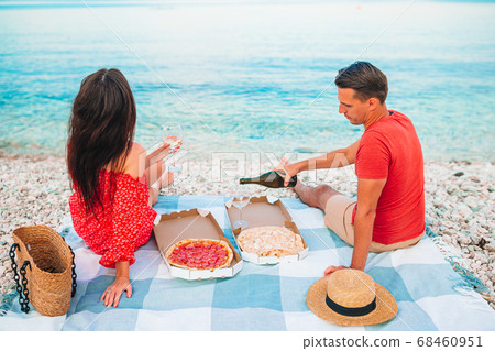 Family having a picnic on the beach Family having a picnic on the beach 68460951