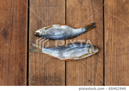 two of roach traditional salted fish from Astrakhan on the dark wooden boards, horizontal on top 68462946