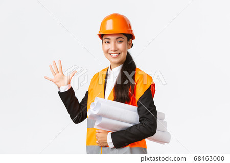Smiling professional asian female engineer, architect giving five month for construction, carry blueprint of project and looking at camera, guarantee finish work in time, white background Smiling professional asian female engineer, architect giving five month for construction, carry blueprint of project and looking at camera, guarantee finish work in time, white background 68463000
