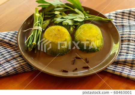 Two portions of frozen green broth on a dark plate, close-up Two portions of frozen green broth on a dark plate, close-up 68463001