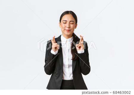 Hopeful optimistic businesswoman having faith in herself, believe dreams come true, cross fingers for good luck and close eyes as making wish, praying for relish, white background Hopeful optimistic businesswoman having faith in herself, believe dreams come true, cross fingers for good luck and close eyes as making wish, praying for relish, white background 68463002