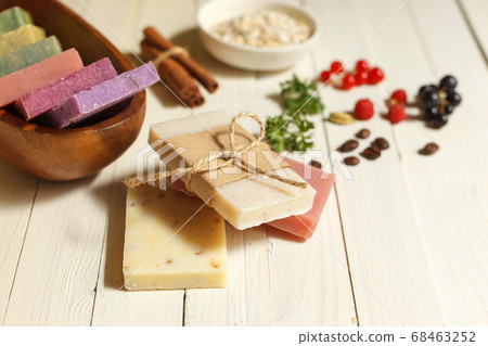 Colored natural soap and ingredients for cooking on a white wooden surface. Horizontal orientation with space 68463252