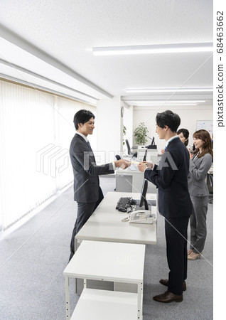 Young employees receiving special bonus 68463662