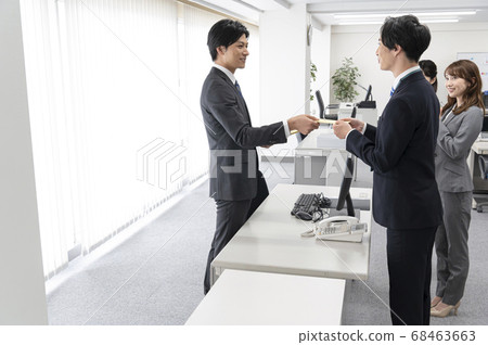 Young employees receiving special bonus 68463663