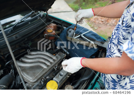 Mechanic hands checking oil level Mechanic hands checking oil level 68464196