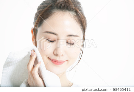 Young Japanese woman wiping sweat with towel Young Japanese woman wiping sweat with towel 68465411