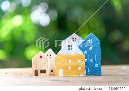 Closed up tiny home model on floor or wood board 68466331