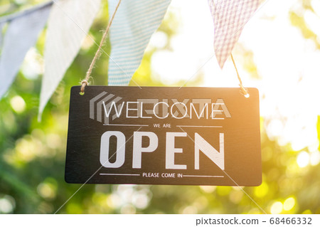 A business sign that says open on cafe or 68466332