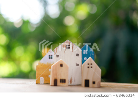 Closed up tiny home model on floor or wood board 68466334