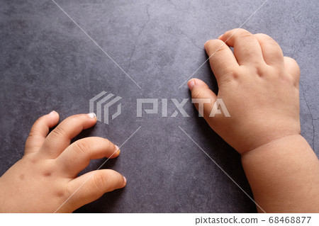 top view of baby hand on black background. 68468877