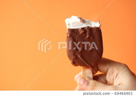 women hand holding chocolate ice cream with copy space women hand holding chocolate ice cream with copy space 68468901