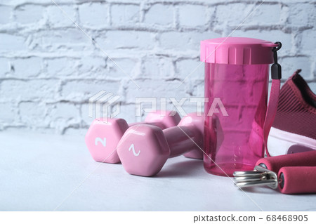 pink color dumbbell, shoe and water bottle on white background pink color dumbbell, shoe and water bottle on white background 68468905