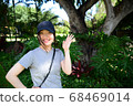 Woman posing in front of trees 68469014