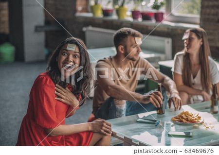 Friends playing Sticky head game at the party 68469676