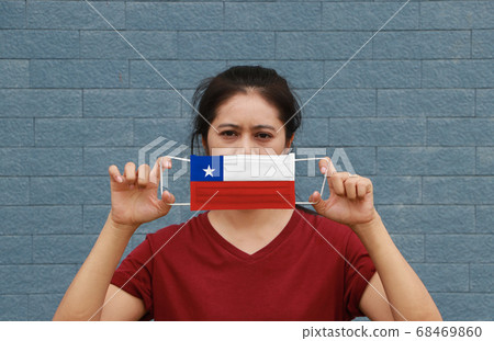 A woman and hygienic mask with Chile flag pattern A woman and hygienic mask with Chile flag pattern 68469860