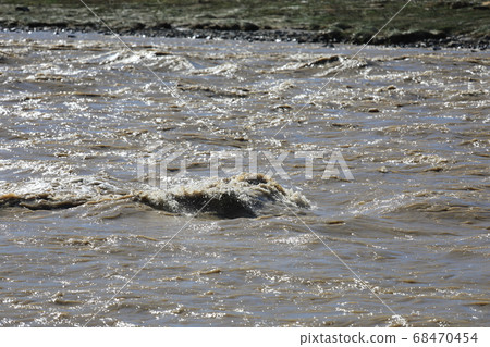 A river that has been flooded by heavy rain 68470454