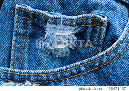 Lacking small pocket in the front pocket of blue jeans.  68471467