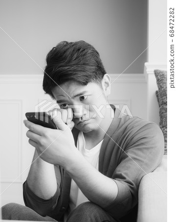 Asian young man rubbing his tired eyes his Asian young man rubbing his tired eyes his 68472282