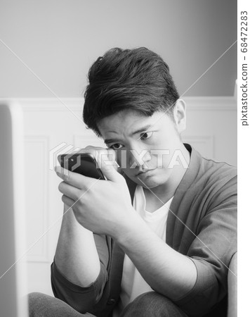 Asian young man rubbing his tired eyes his Asian young man rubbing his tired eyes his 68472283